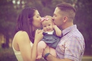 Couple Kissing Baby - dentist asheville