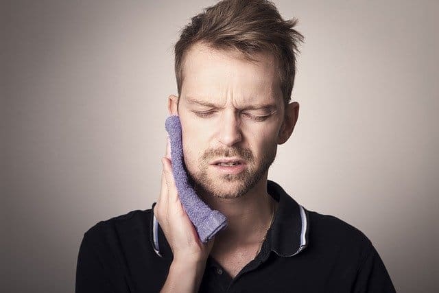 A man in pain, needs a Dental Emergency Procedure